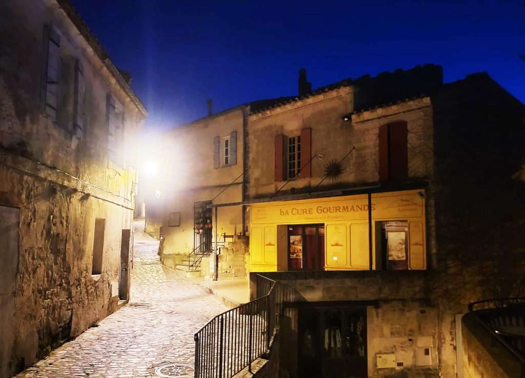 Quaint street illuminated at night with ANETHIC's lightgogokit smart outdoor lighting kits