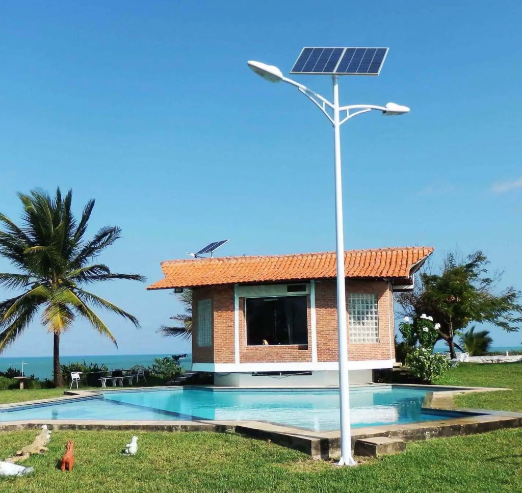 Split-type solar street lights installed on standard poles by a swimming pool in Brazil