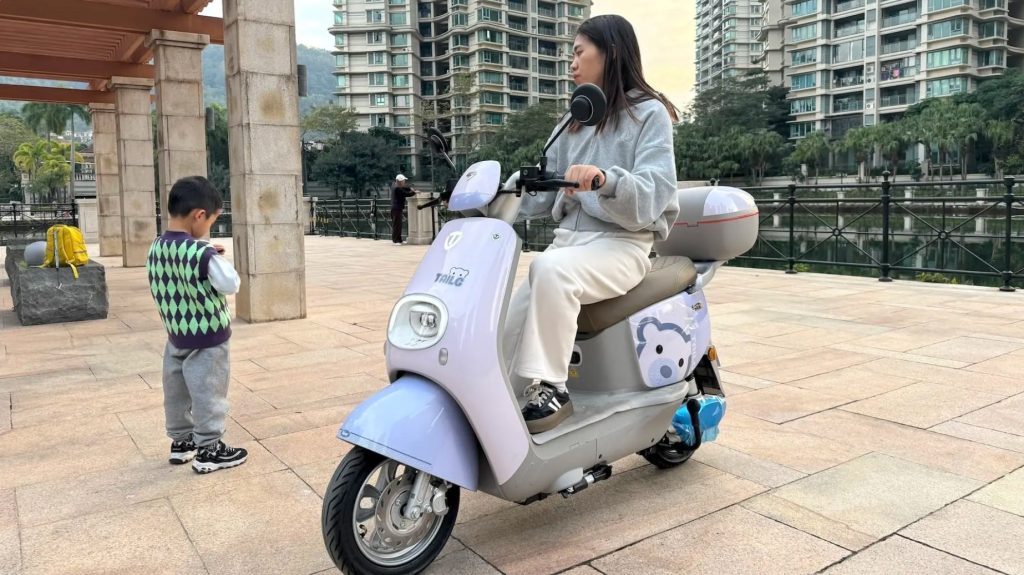 Person on scooter near child