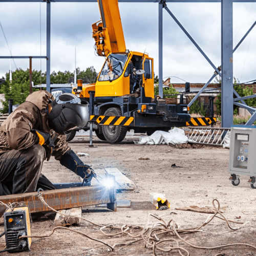 Worker welding in construction site.